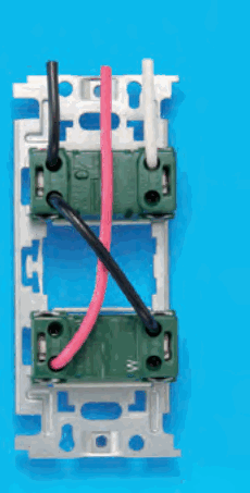 取付枠に緑色の器具が上下に2個付いたものの裏面(下の器具の右側にWの字)。黒色の電線は上の器具の左上へ,白色の電線は上の器具の右上へ入る。上の器具の左下と下の器具の右上を黒色の渡り線で斜めに結び,赤色の電線は下の器具の左下へ入る