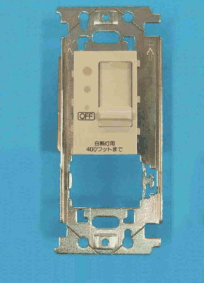 取付枠に付いたクリーム色の器具。縦長のつまみと3つの小さな丸い点,OFF の表示と 白熱灯用 400ワットまで の字がある